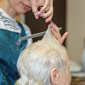 older lady getting hair cut