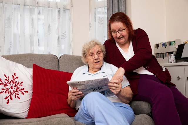 2 women reading on sofa