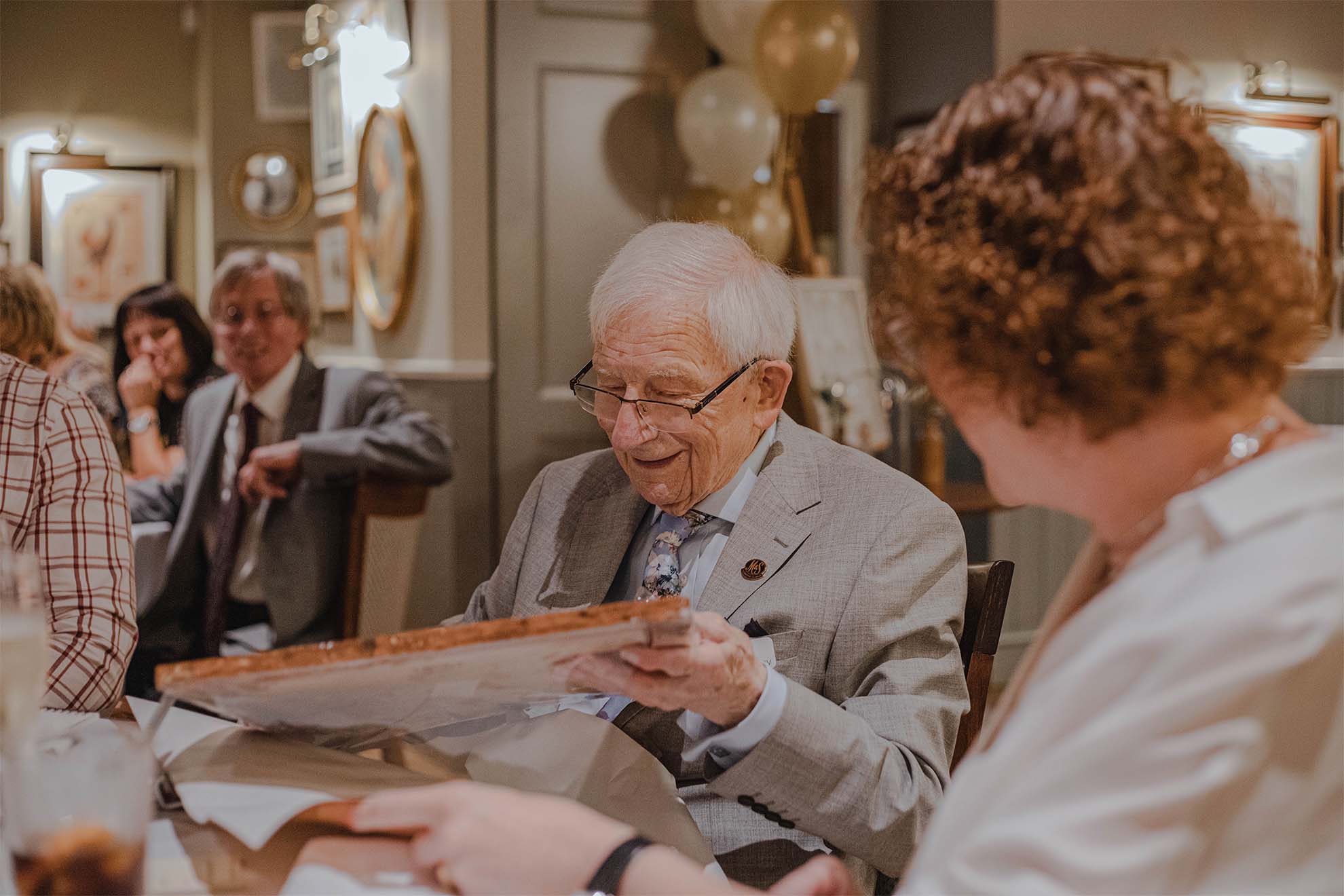 old man looking at a picture