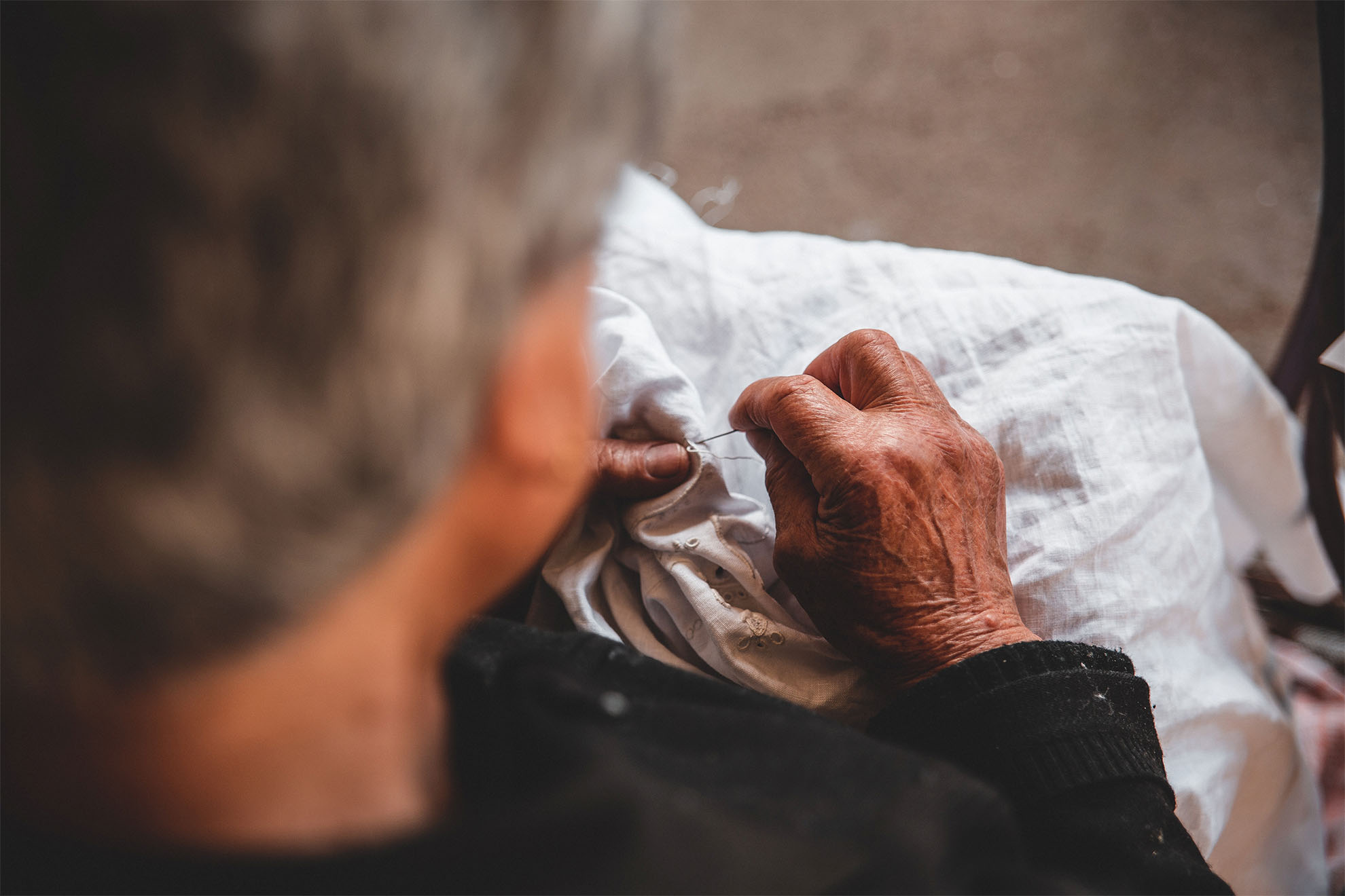 person embroidering