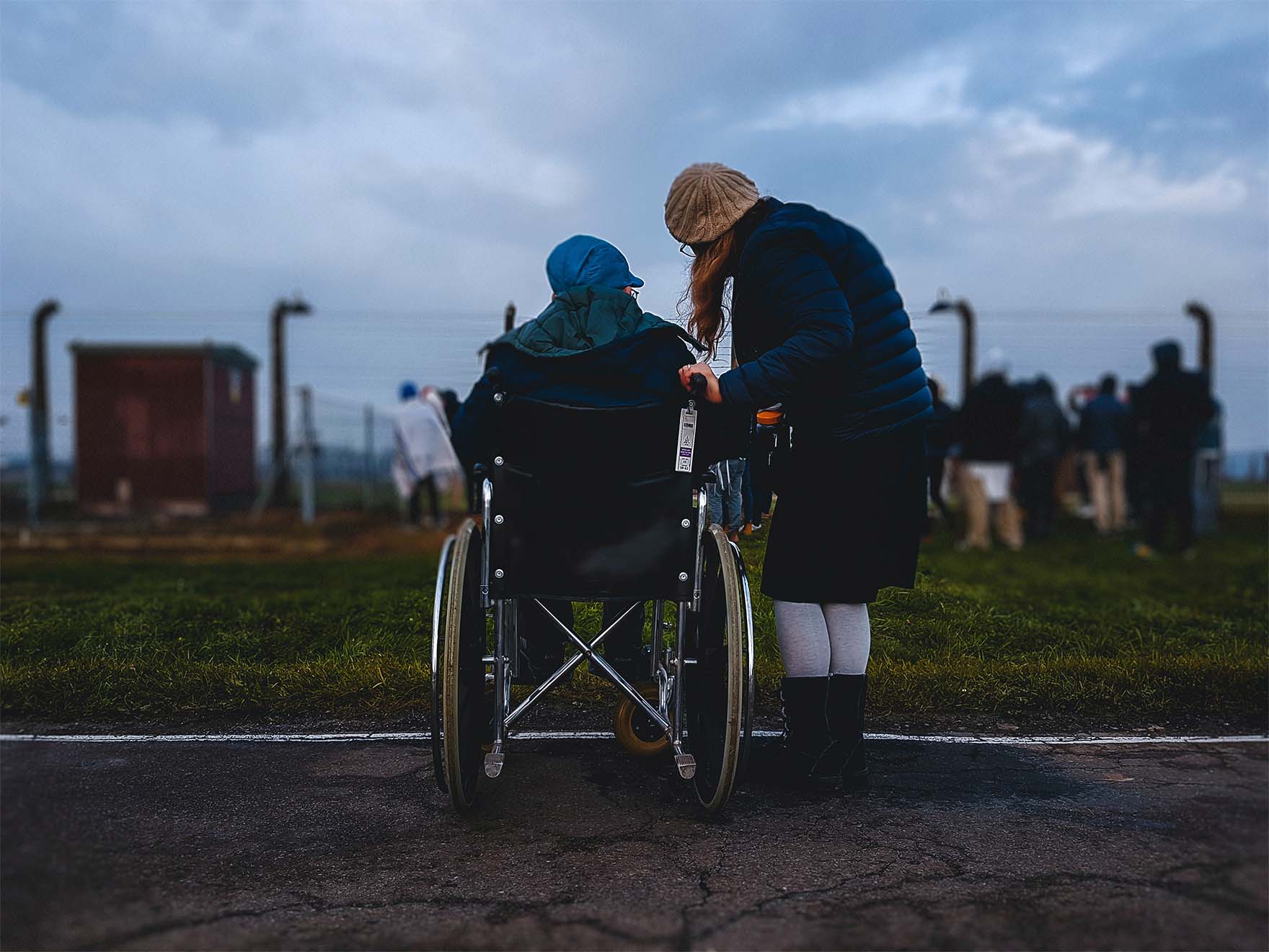 2 people, one in wheelchair looking over fields