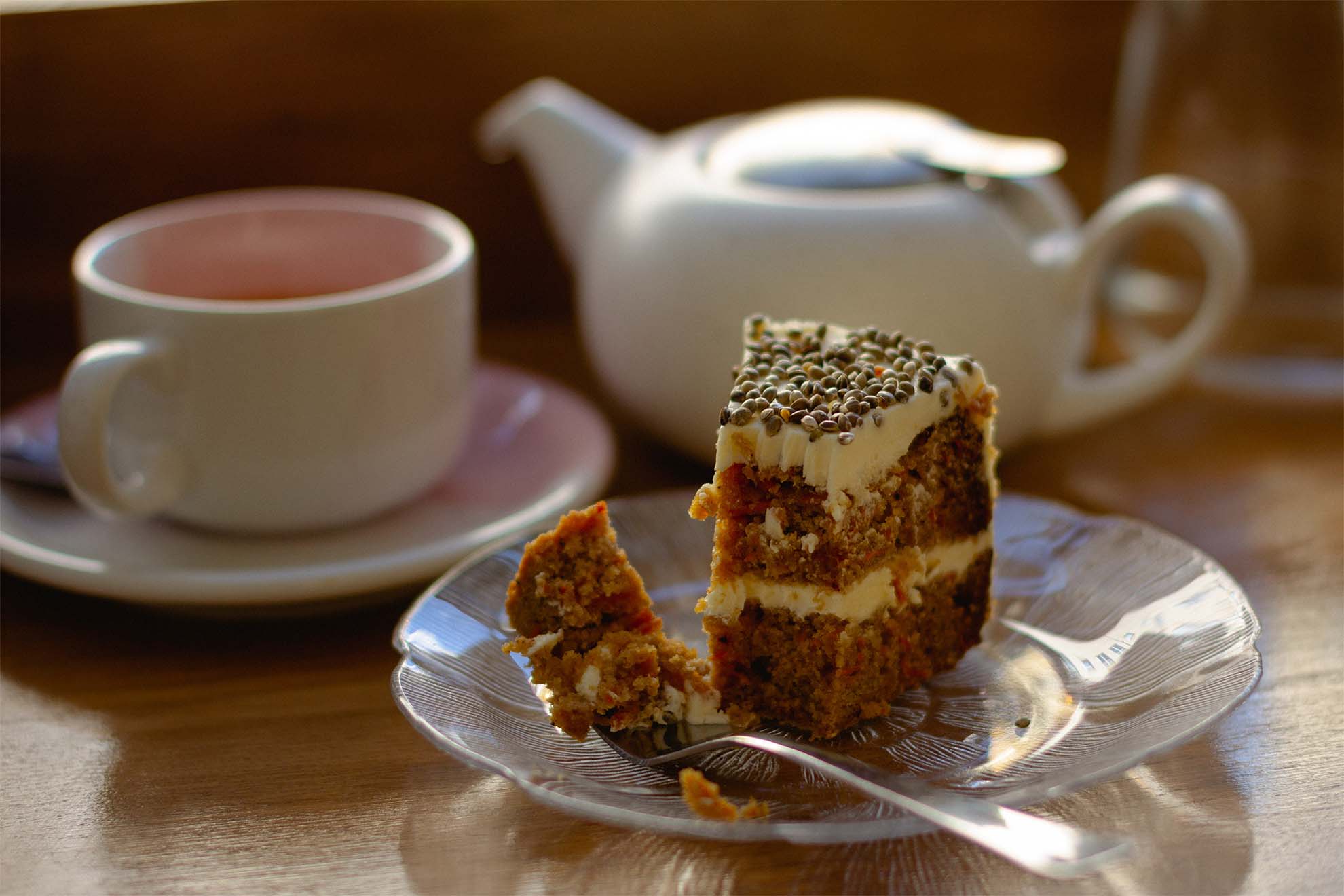 slice of cake with teapot in background