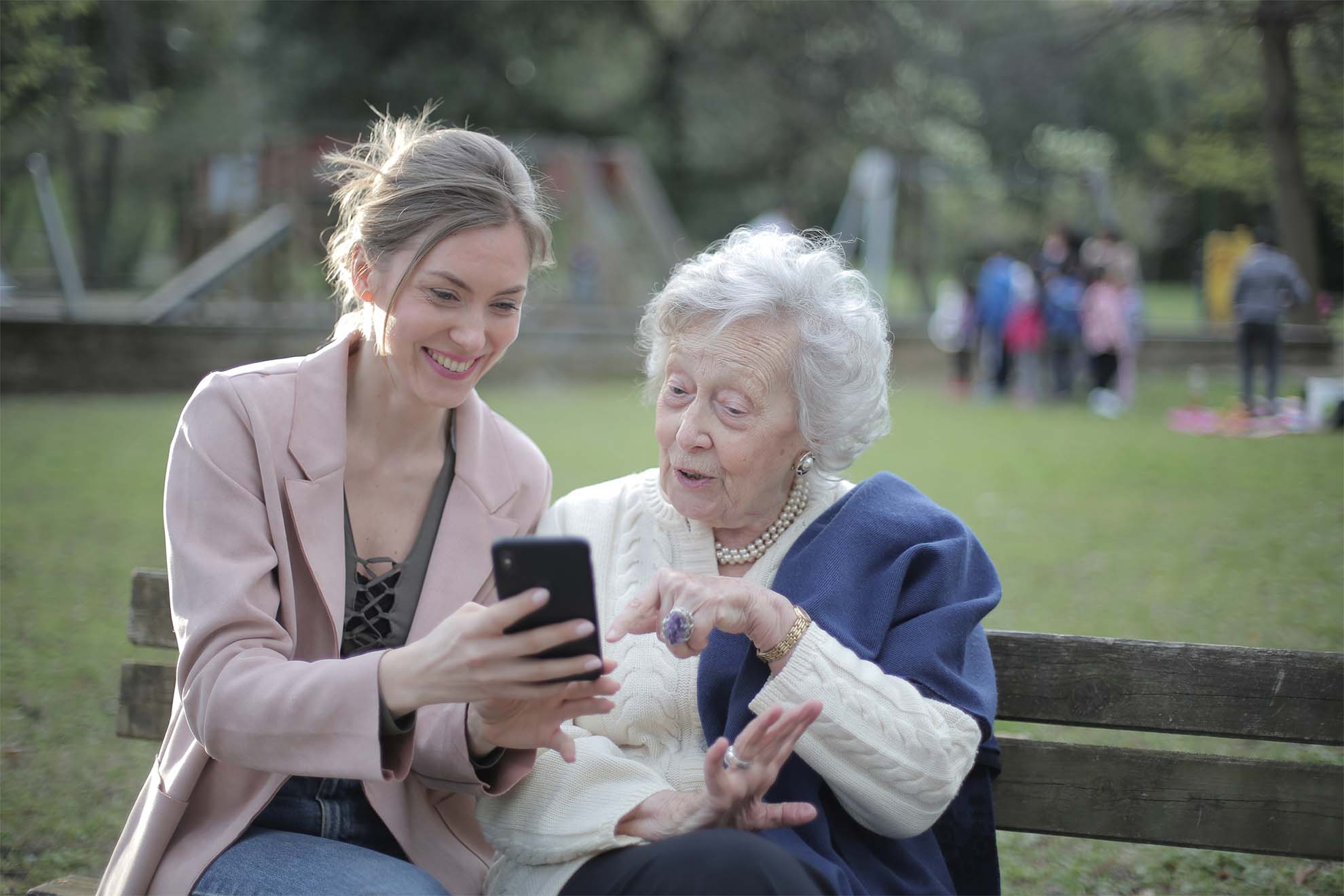 older lady with younger lady looking at phone