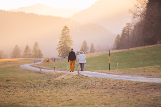 couple walking across a golf course