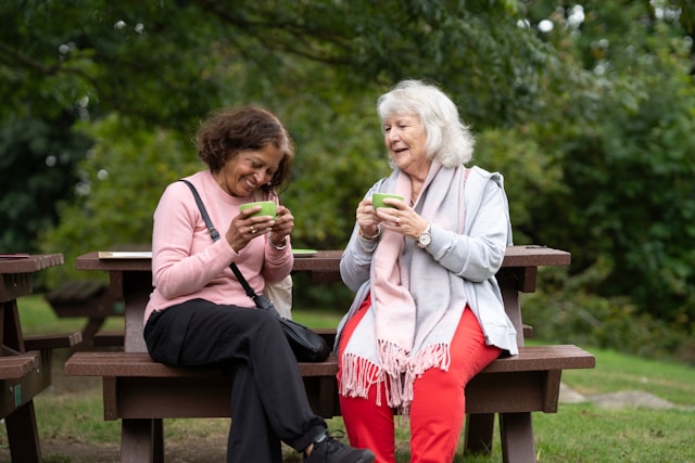 2 older ladies having tea outside