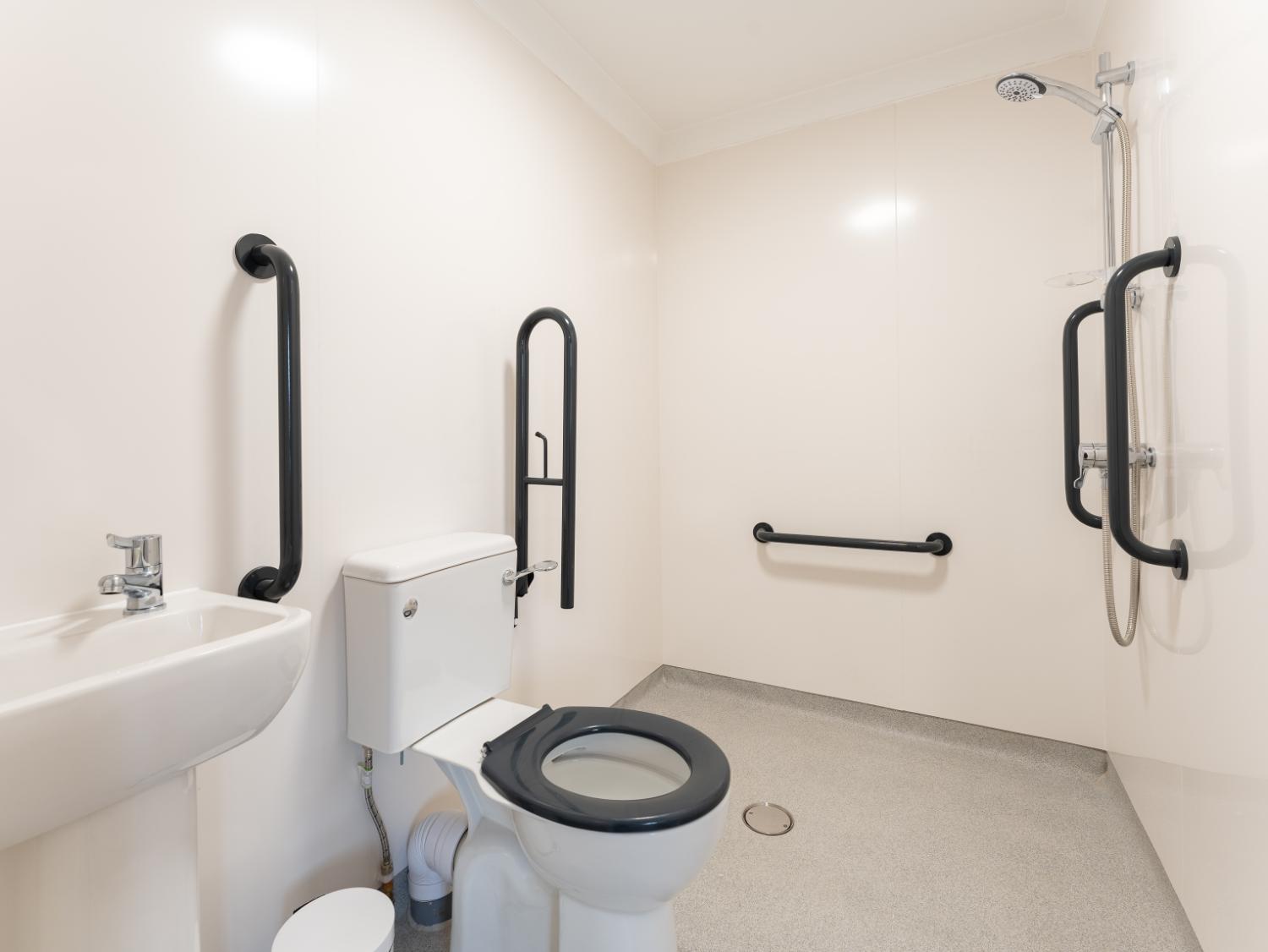 bright accessible wet room with handrails